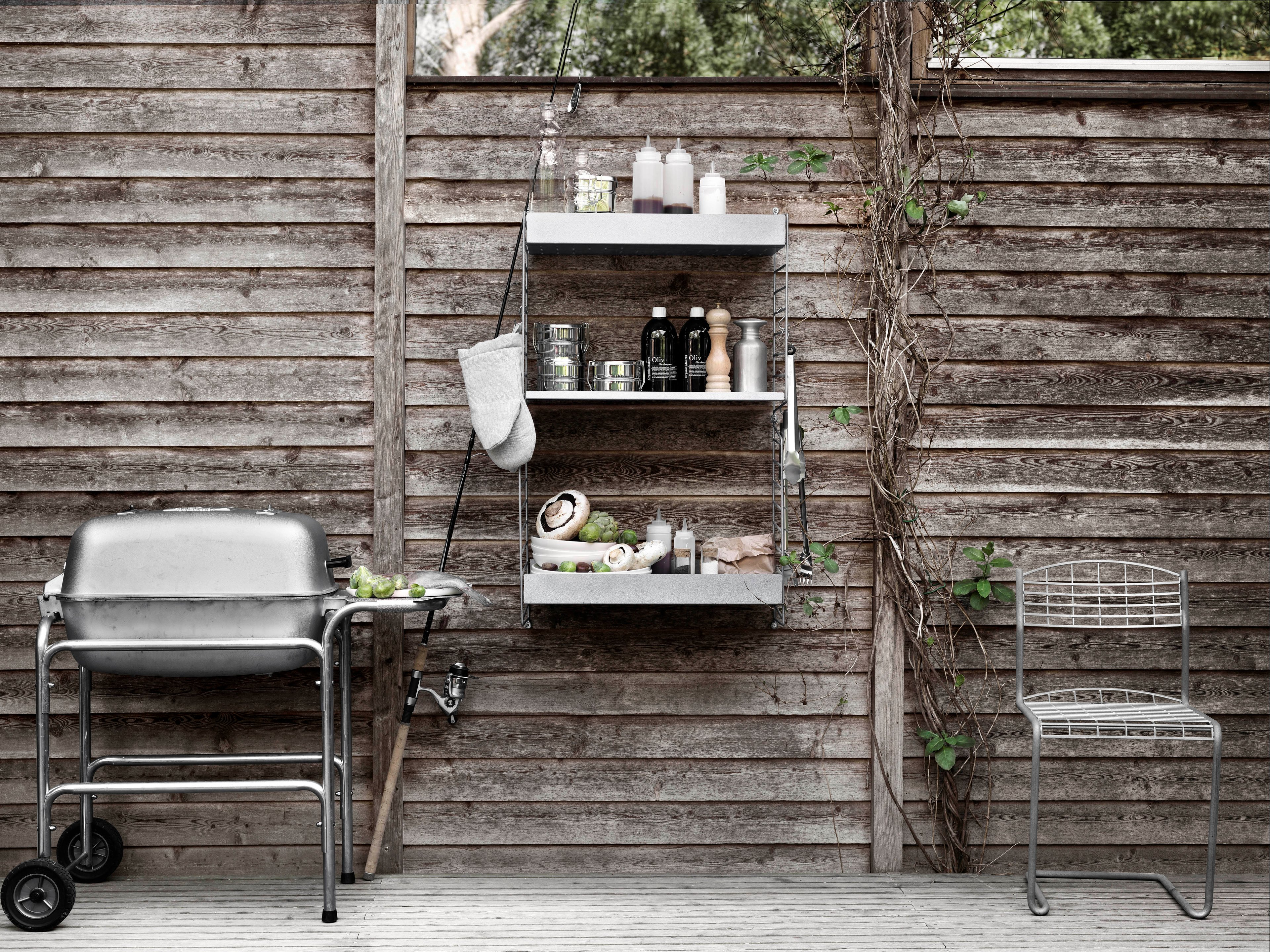 Wall mounted outdoor solution from String. Galvanized wall panels and shelves high and low.