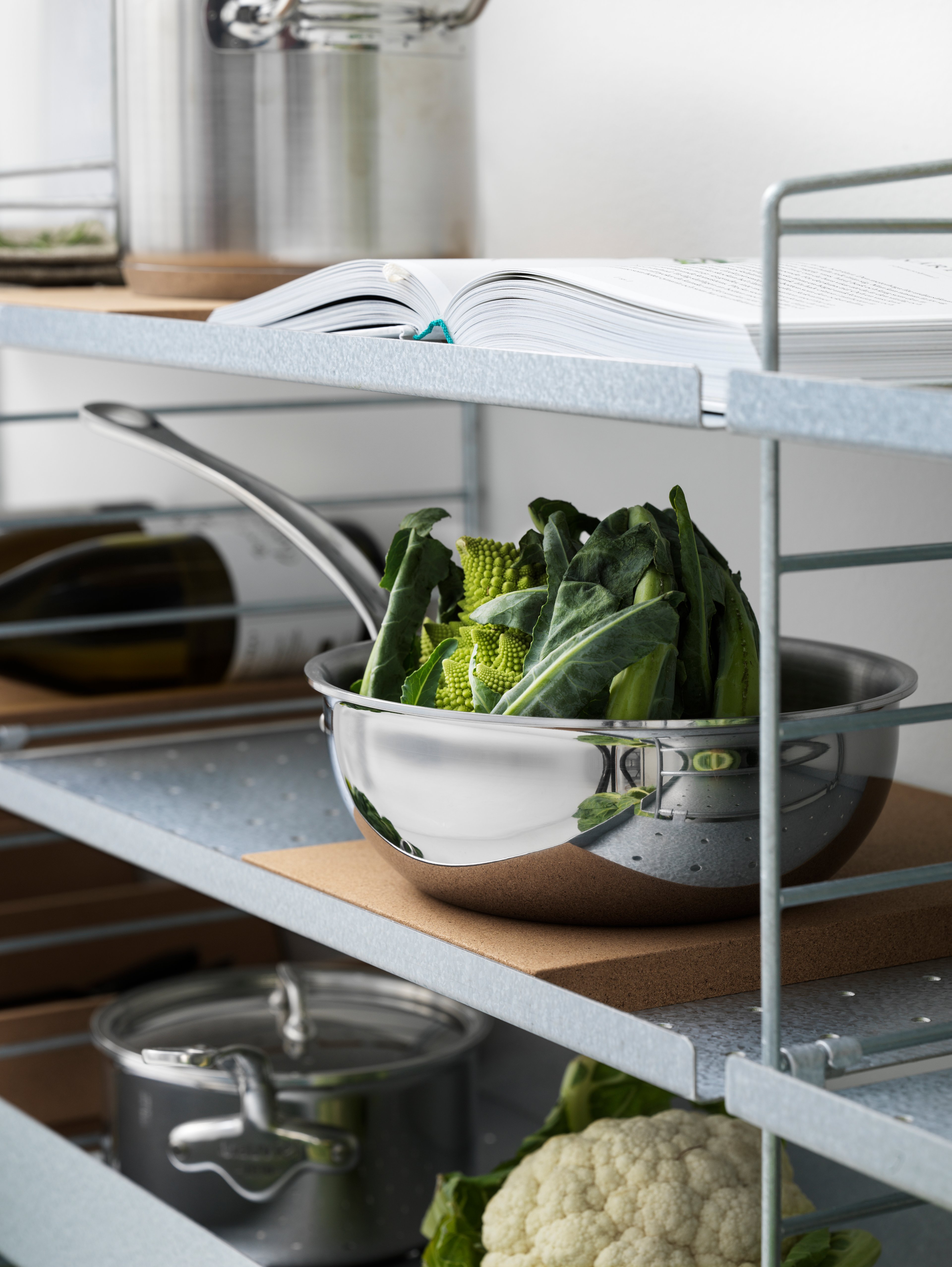 String shelf with floor panels from String System. Galvanized shelves and metal shelves with low edge in white along with underlays in cork. Perfect kitchen accessories.