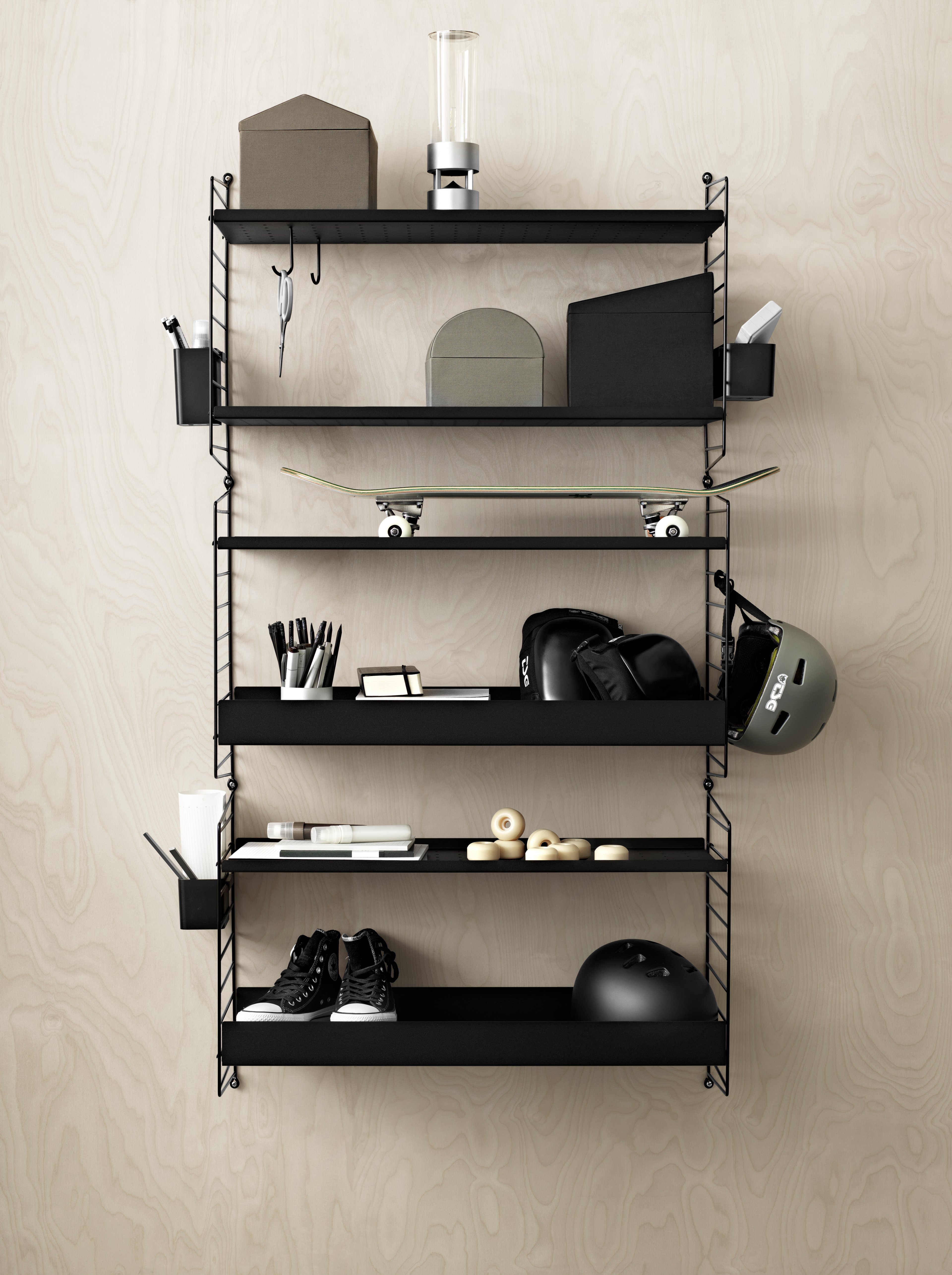 Wall mounted kids room solution from String. Wall panels, metal shelves, organizers and hooks in black.