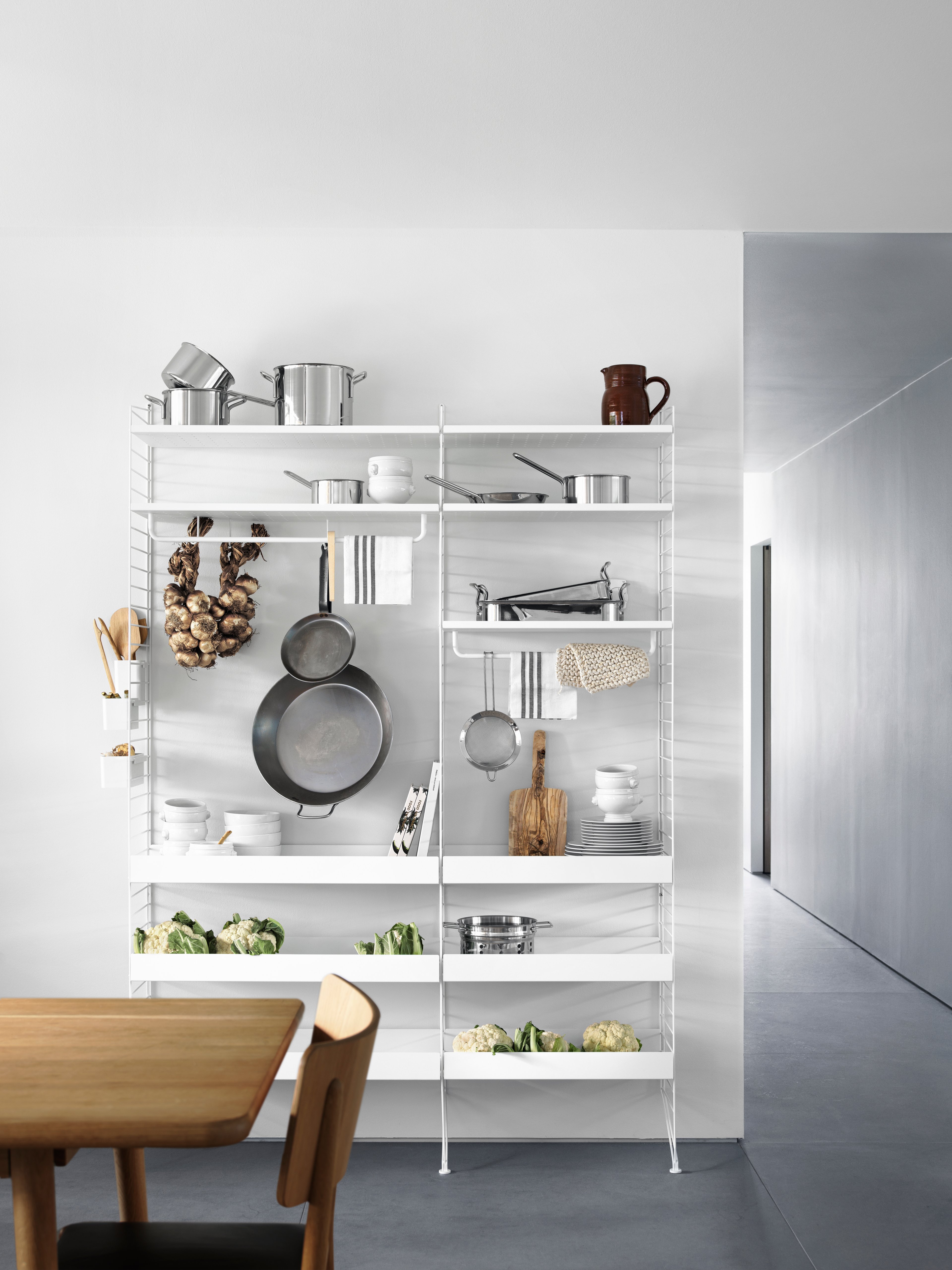 Floor mounted kitchen solution from String. Floor panels, metal shelves, rods and hooks in white.