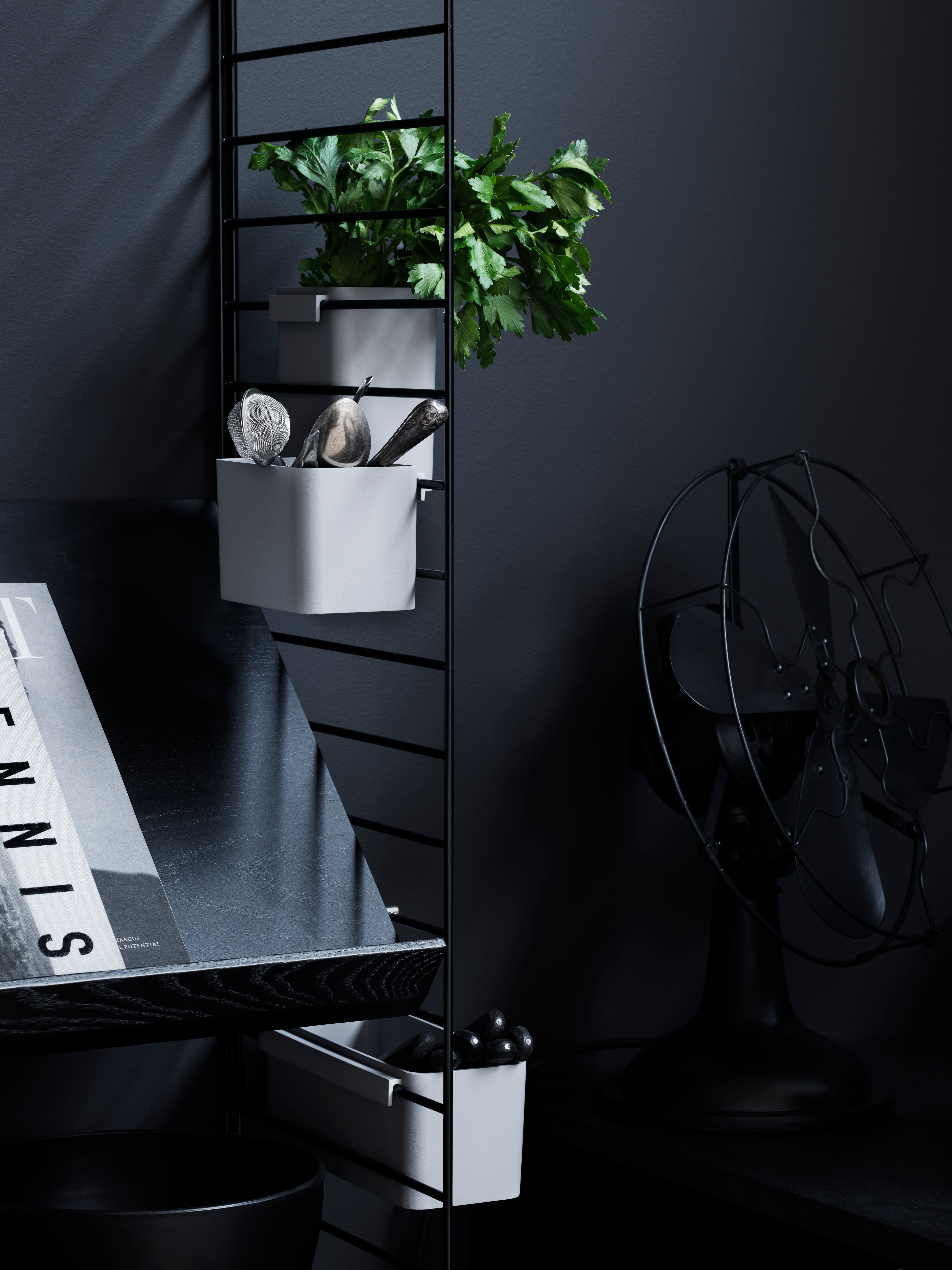 wall panels in black.magazine shelf solid in black stained ash. organizers in white.