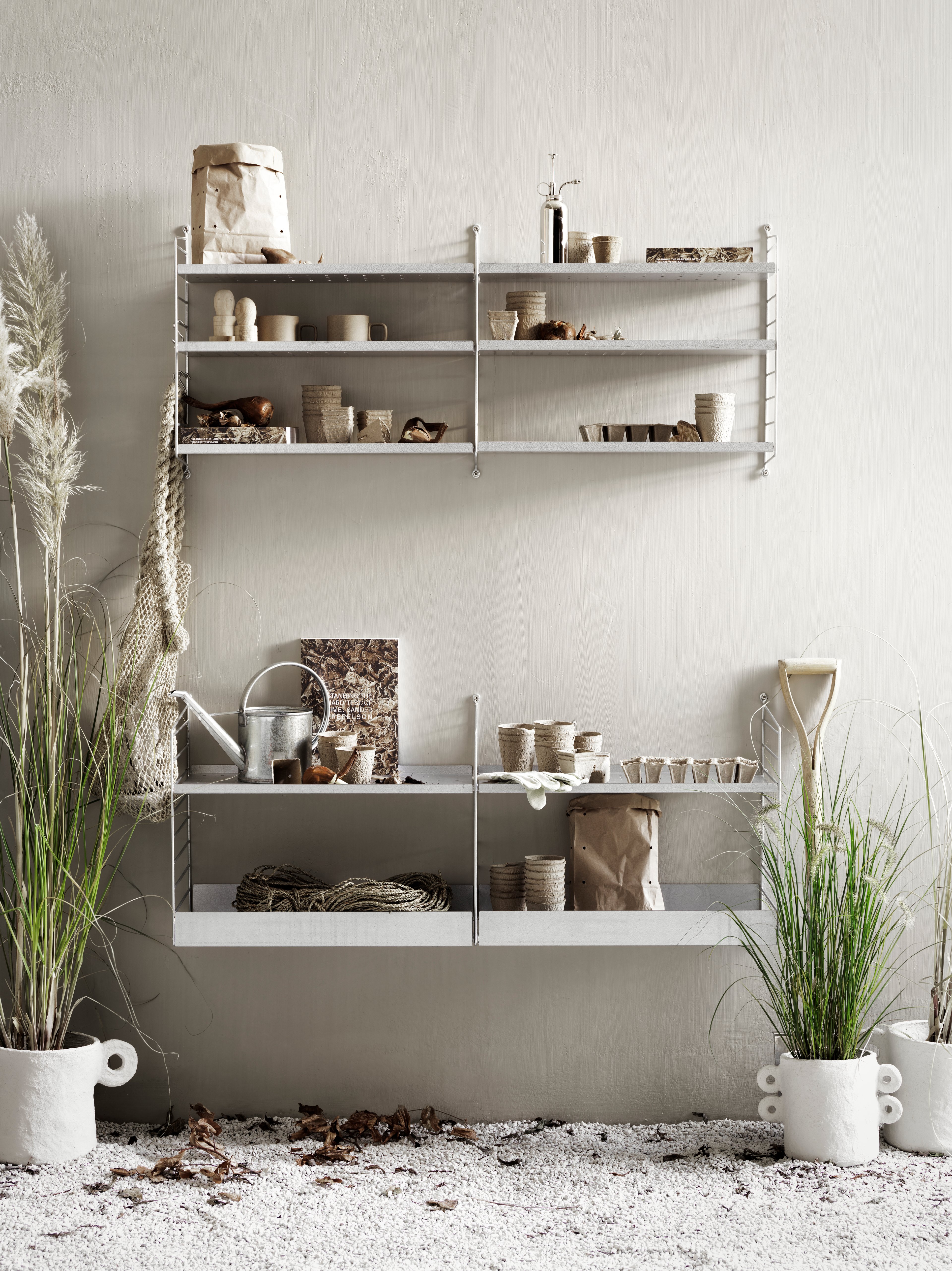 Floor mounted outdoor solution from String. Galvanized wall panels, shelves high and low.