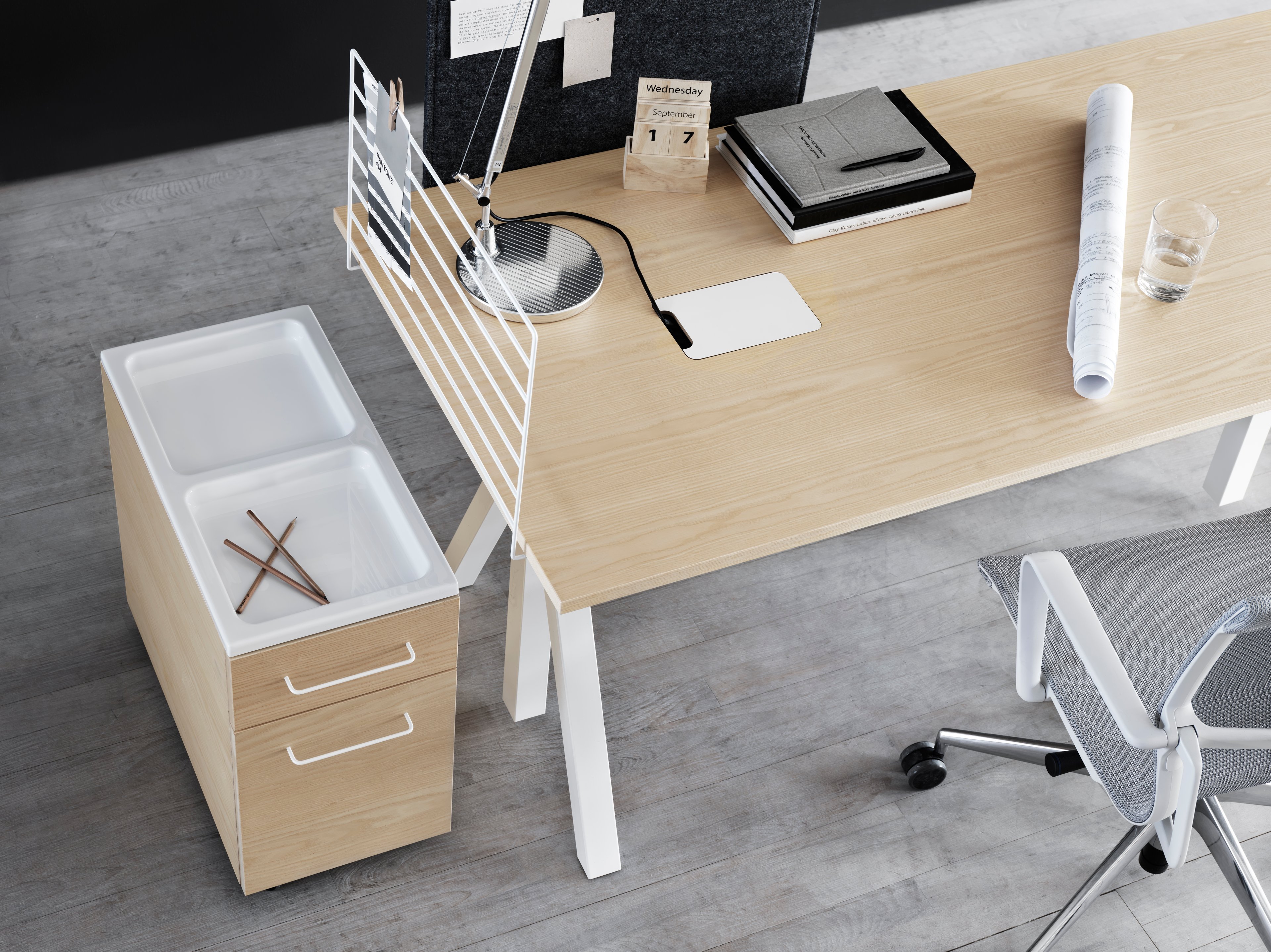 height-adjustable work desks in ash. mobile storage units in ash. wire screen in ash and fabric sleeve in grey.