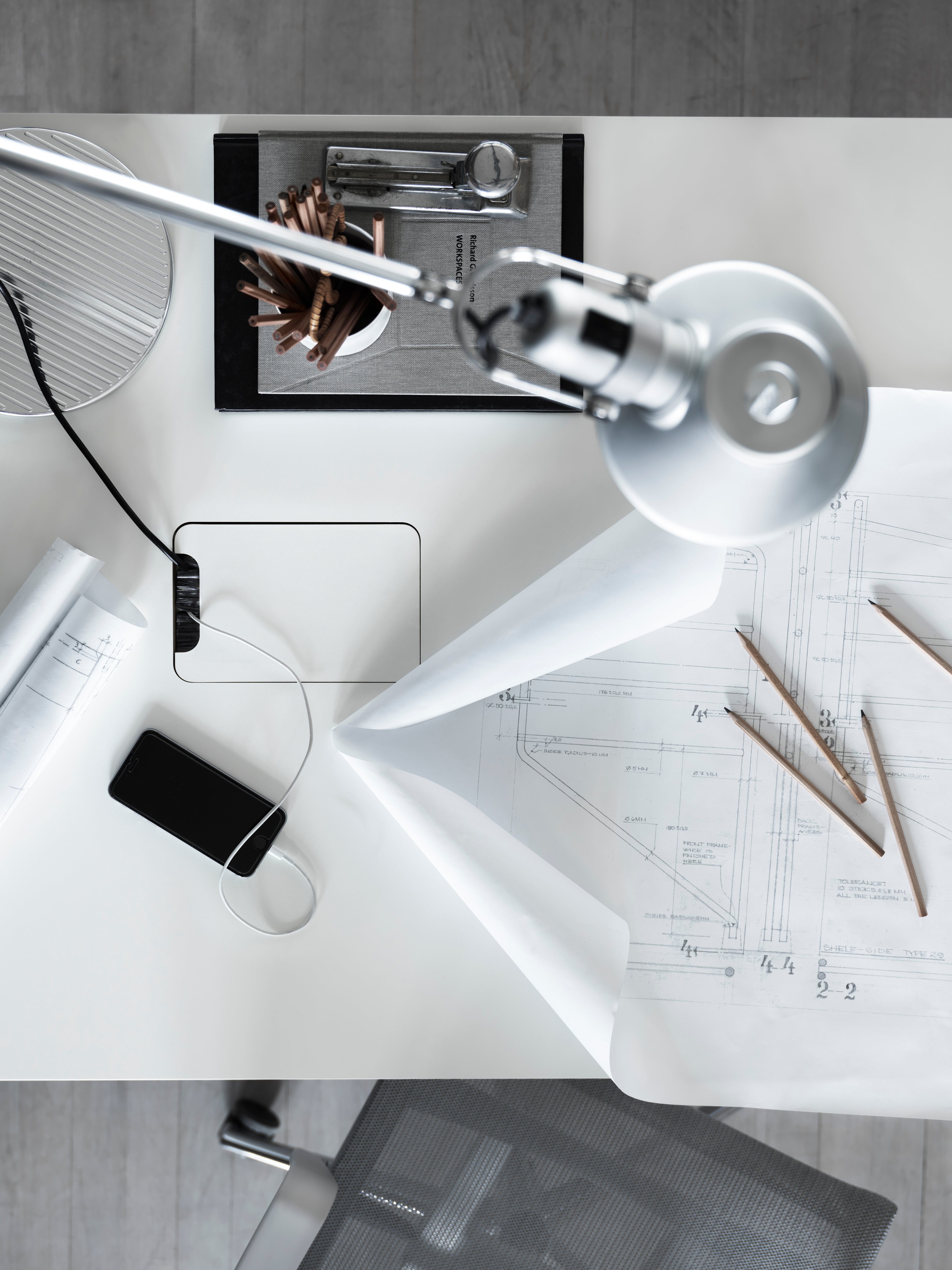 height-adjustable conference table in white.